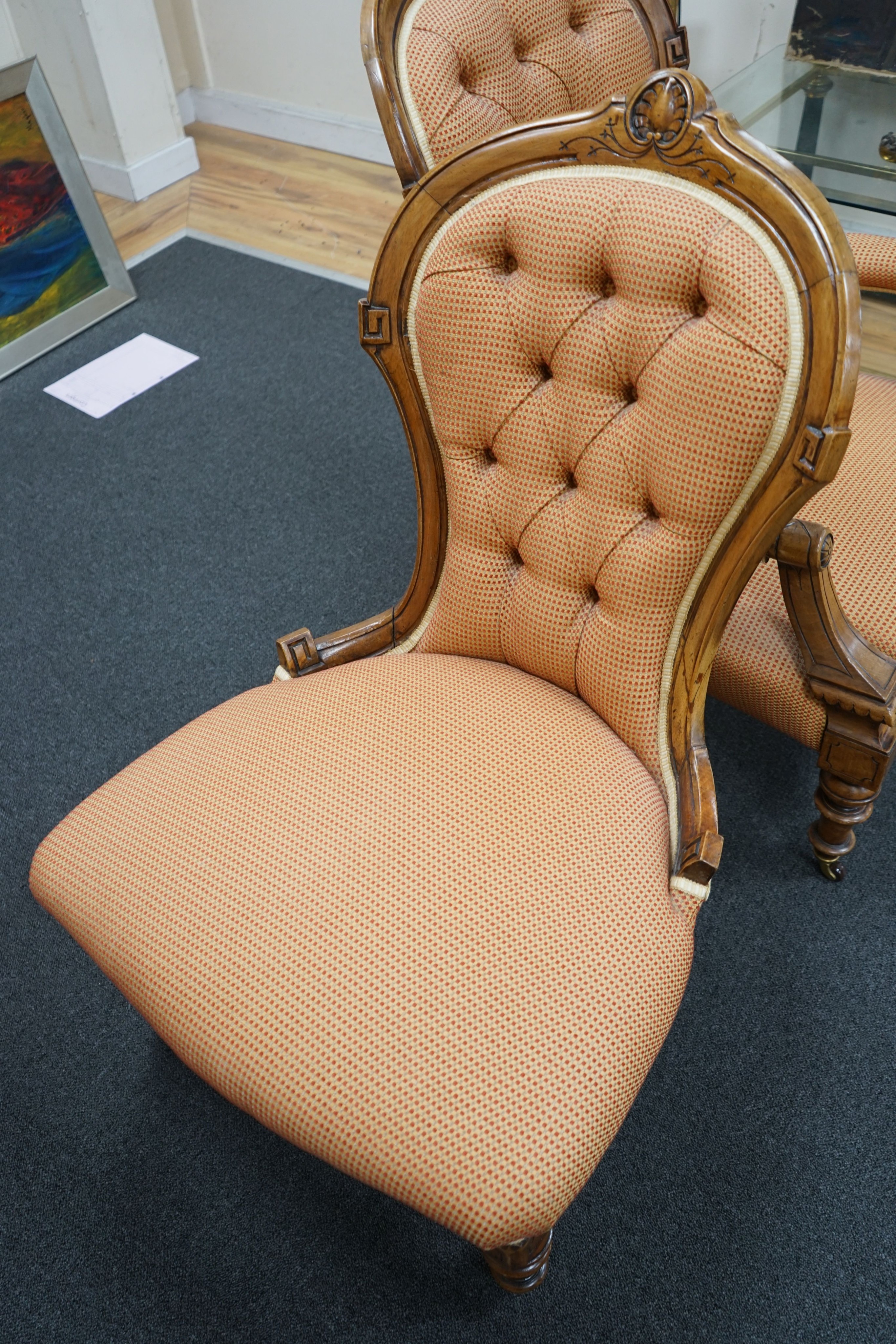 A pair of late Victorian walnut spoon back chairs, one with arms, larger width 68cm, depth 60cm, height 100cm